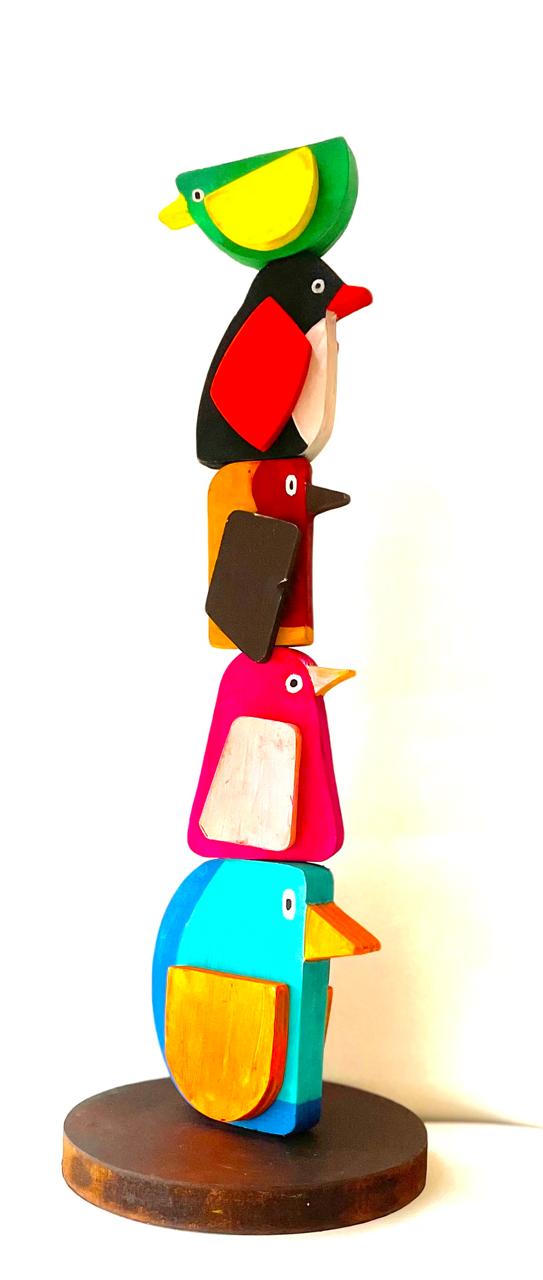 Five wooden birds stacked into a tower